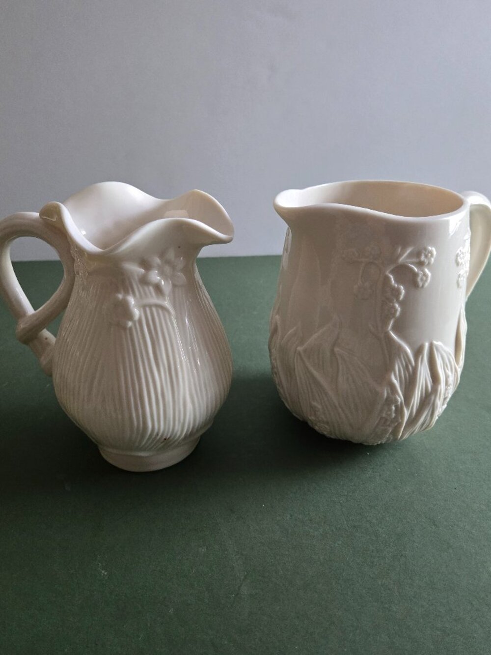 Pair of Ivory Bisque Pitchers
